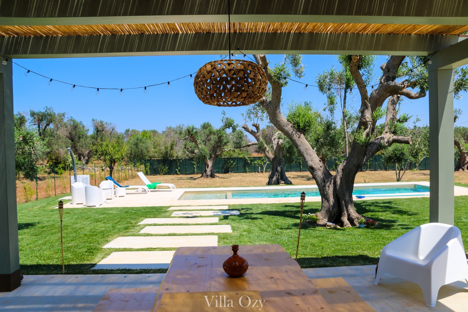 View from the bamboo pergola through olive trees to the pool
